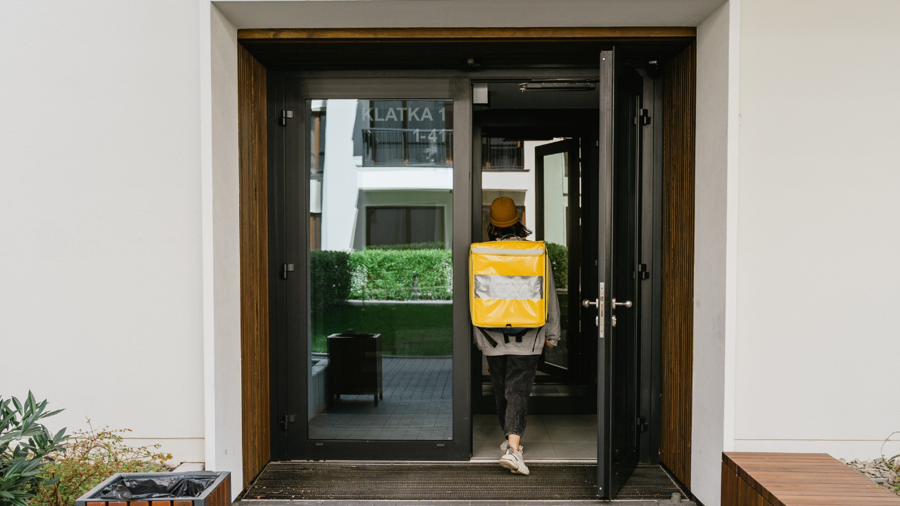 Courier delivering food to a multifamily property.